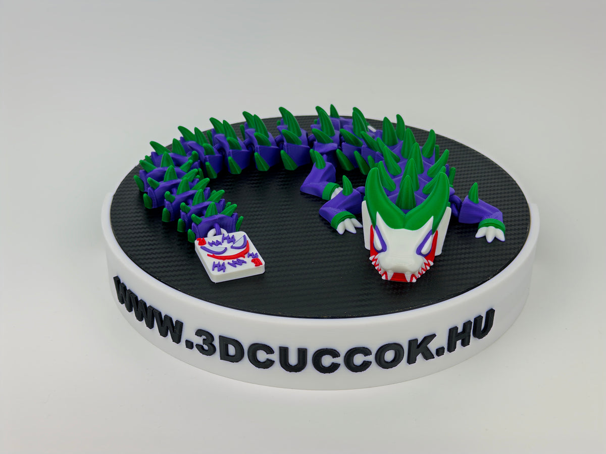 Joker inspirálta zöld-lila sárkány fehér arccal és kártyás farokvéggel